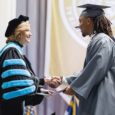 Dr. D. awards student with degree at December grauation