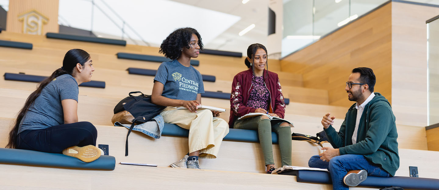 Four students talking in the Parr Center on Central Piedmont's Central Campus