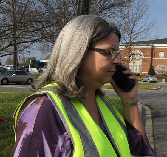 Public Administration faculty member with safety vest outside on campus