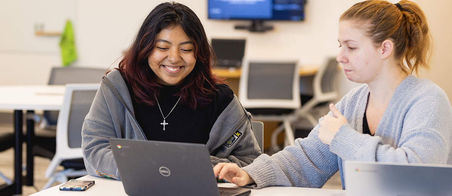 Two Central Piedmont students working together with a laptop