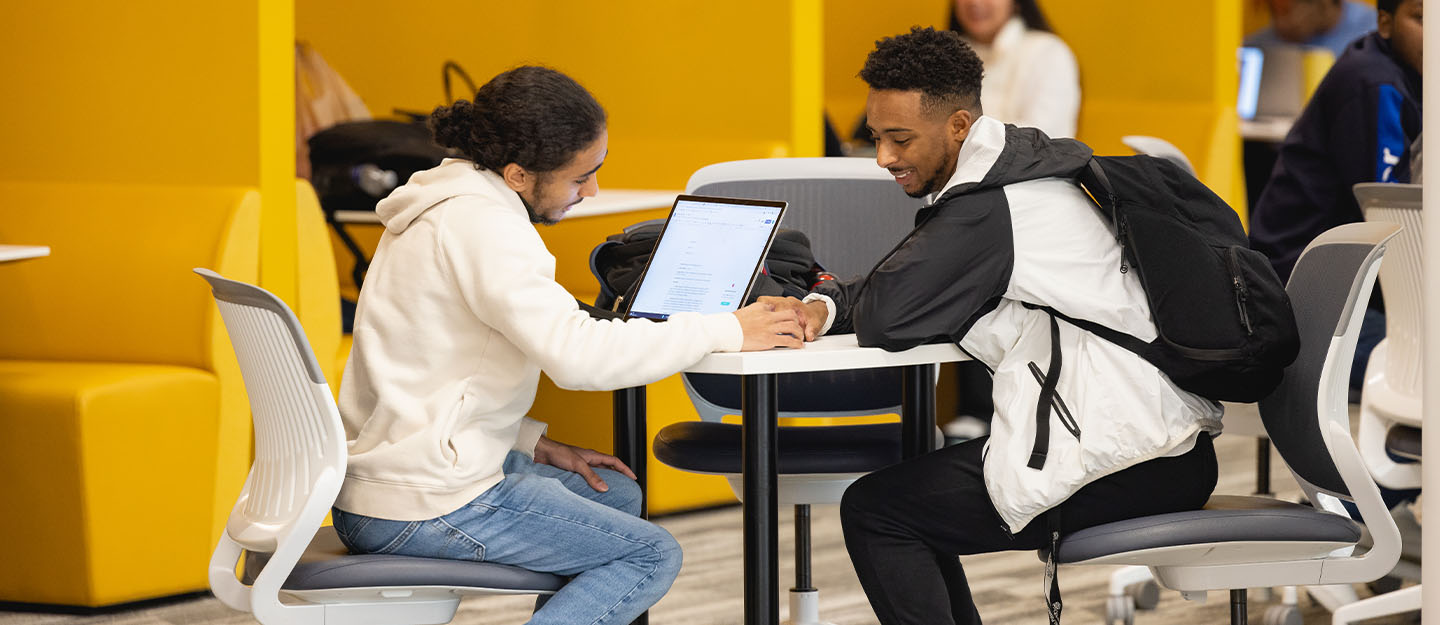 Two students working on a laptop together in the Parr Center