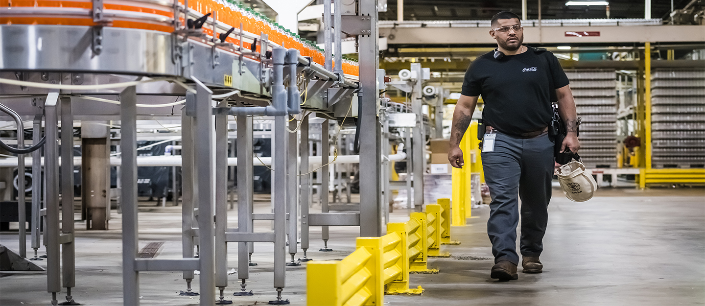 Coca-Cola Consolidated employee walking inside facility