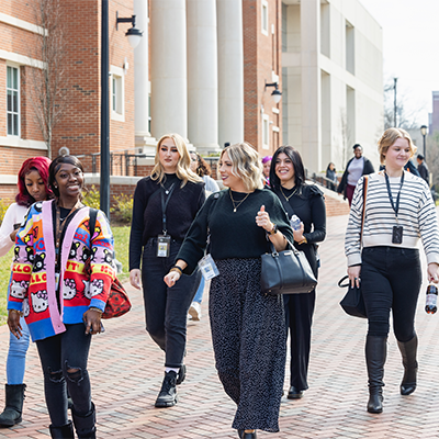 Diverse students guided through campus 