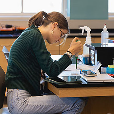 A young Central Piedmont student working in the biology lab