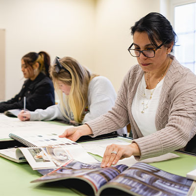 Three Central Piedmont Students working in the classroom