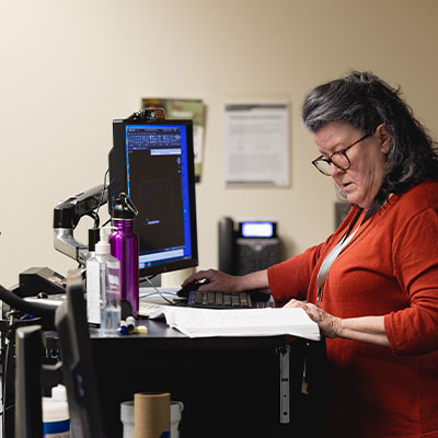 A Central Piedmont faculty member at the podium in a classroom