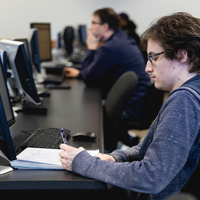 Several Central Piedmont students taking notes in a computer lab