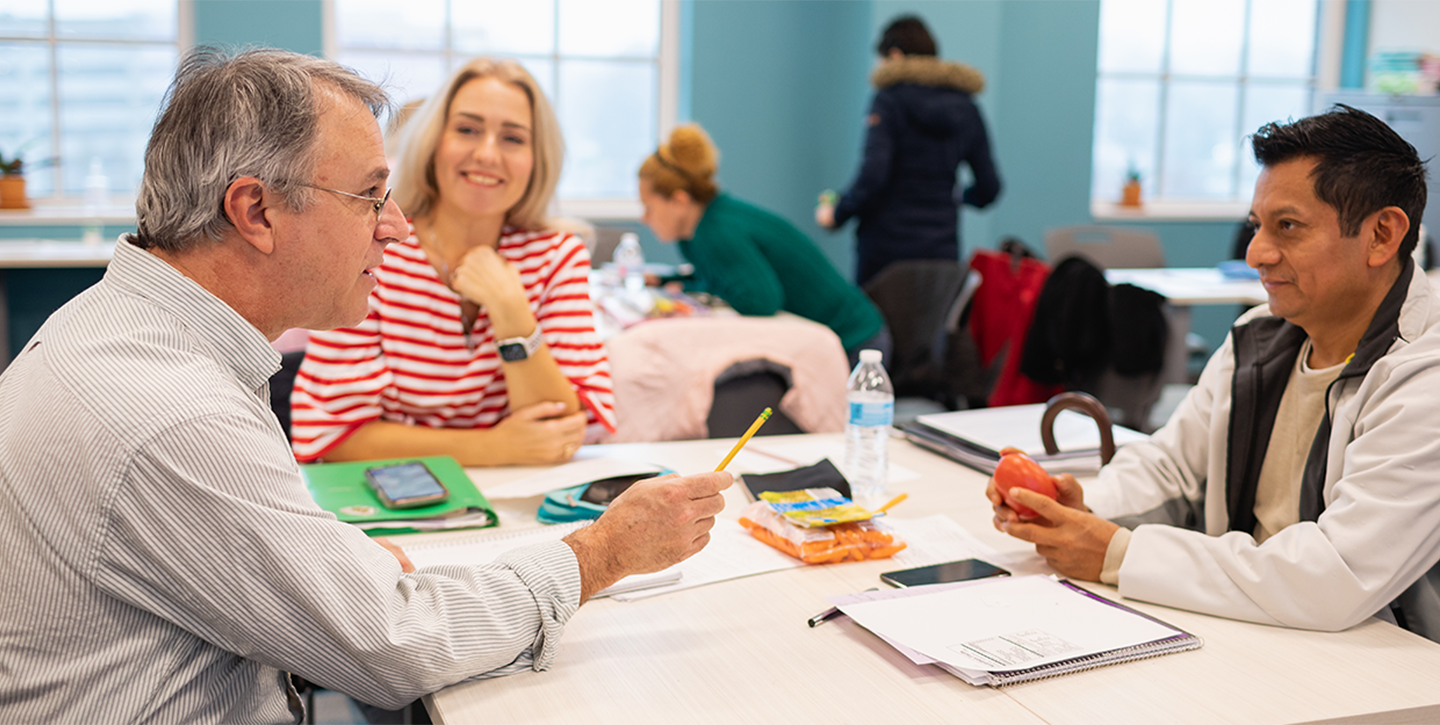 Students at a table working on an assignment 