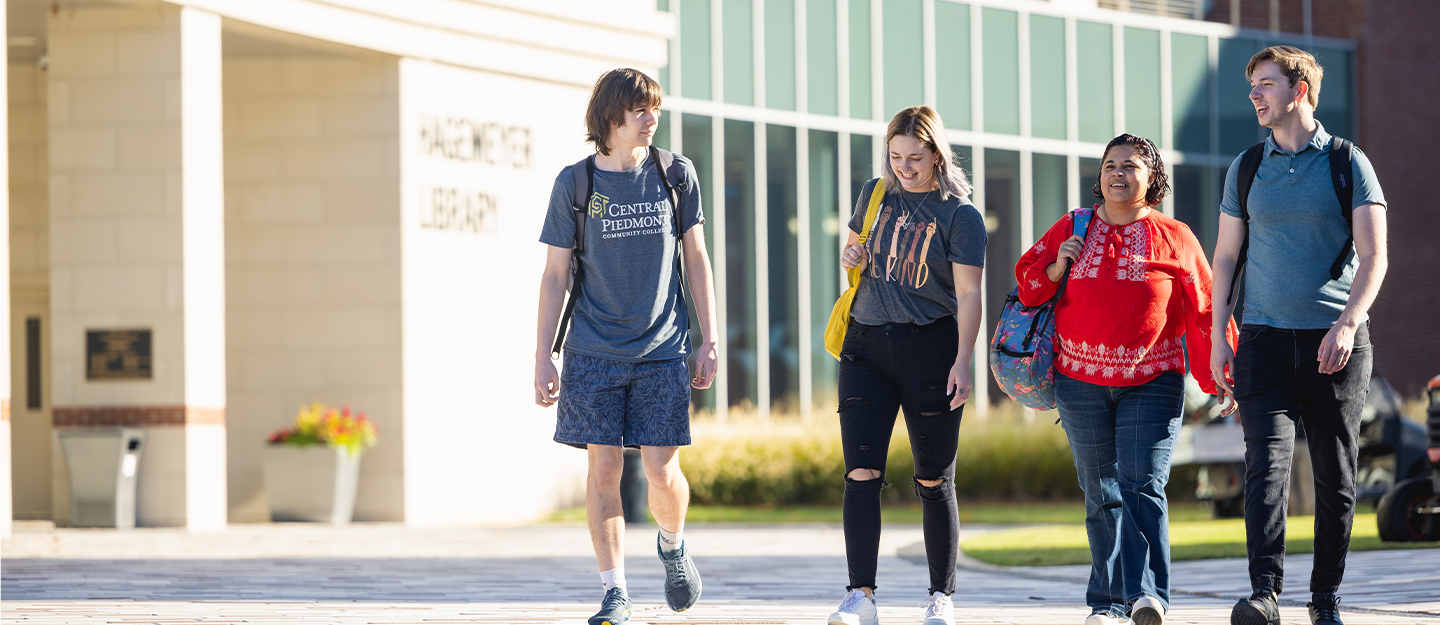 Four students walking past the Parr Center 