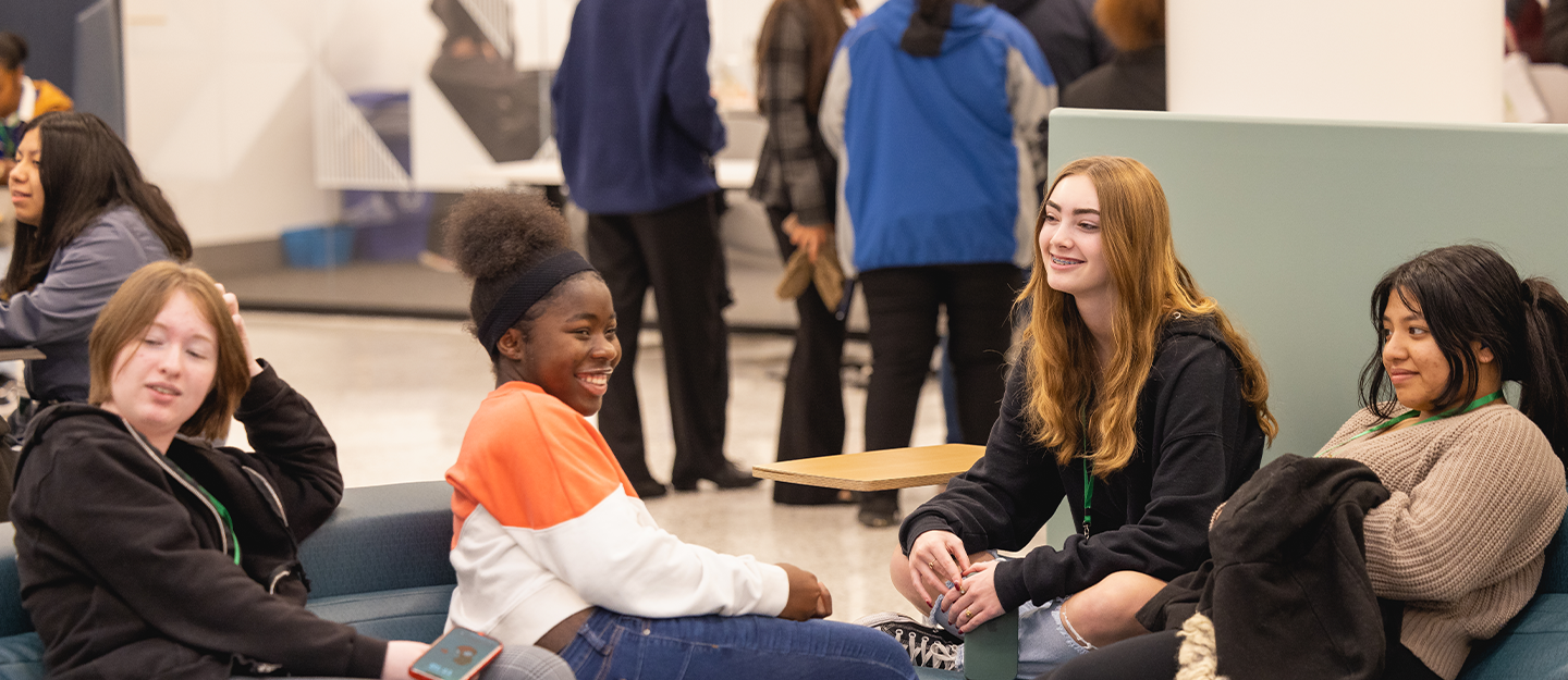 Four students lounging and laughing in the Parr Center 