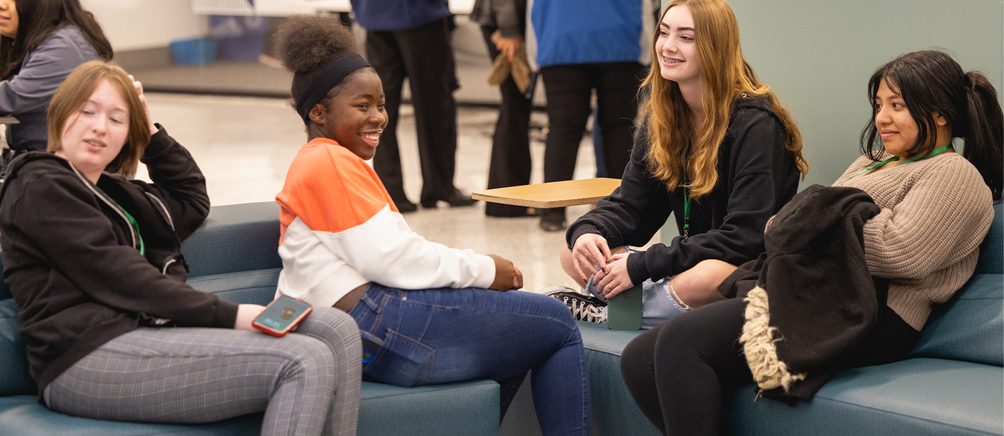 Students laughing while sitting down 