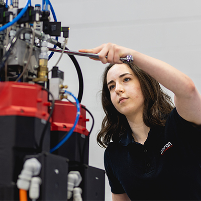 mechatronics student standing in front of equipment