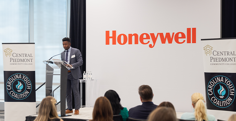 Man giving speech to crowd at Honeywell event 