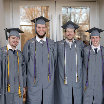 Four Central Piedmont graduates in caps and gowns