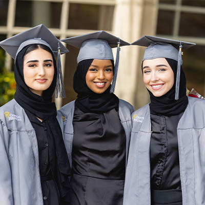 Three Central Piedmont graduates in caps and gowns