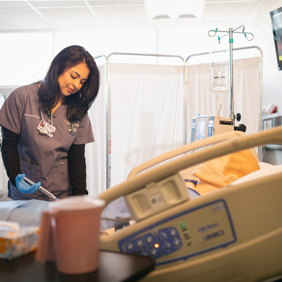 Nurse practicing on mannequin 