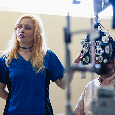 Ophthalmic student checking a patient's eyes