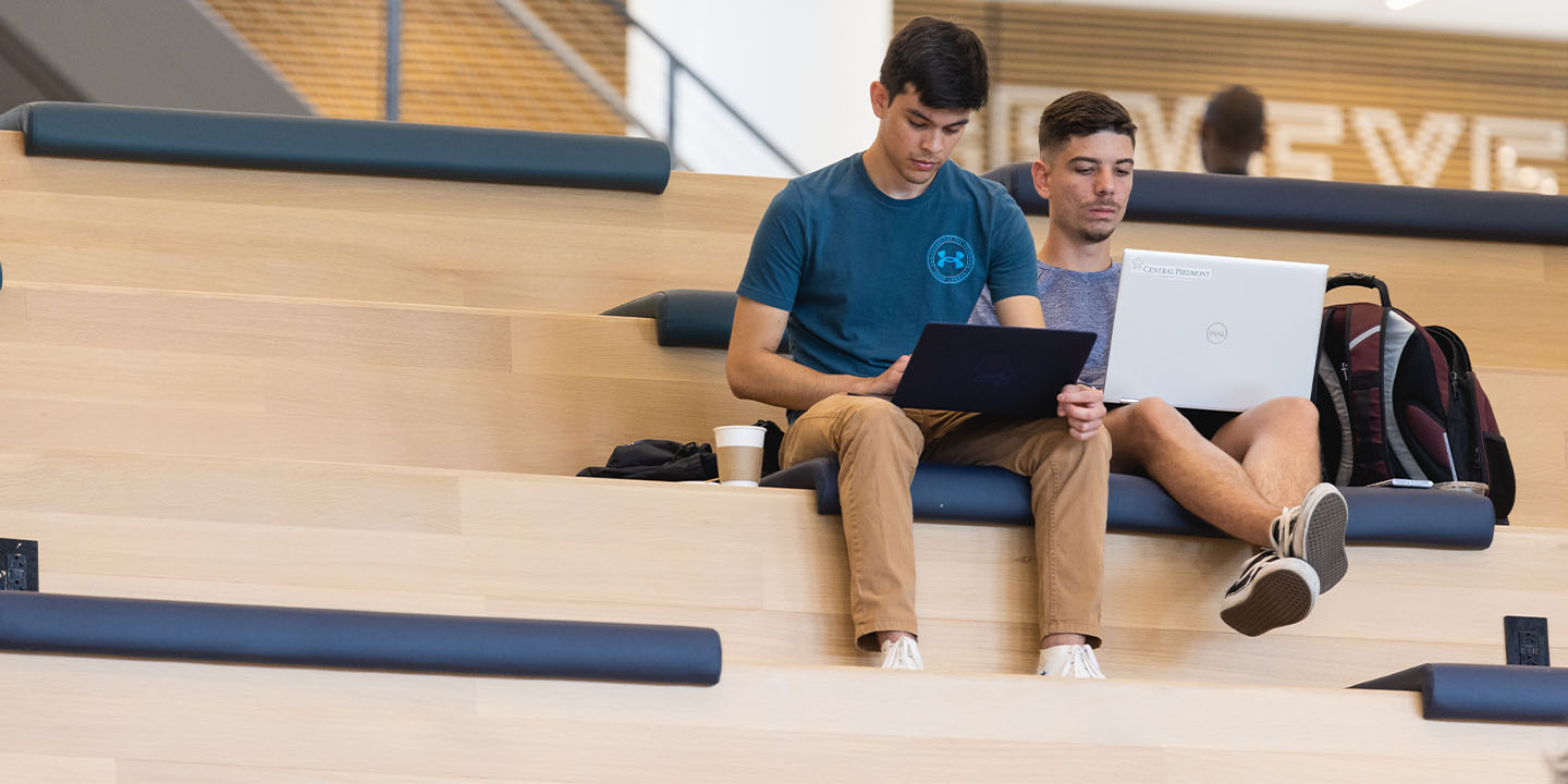 Two students working on Central Piedmont's collaboration stairs