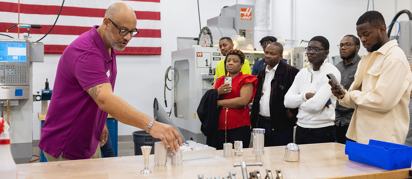 community lunch and learn students and business partners in industrial lab setting 