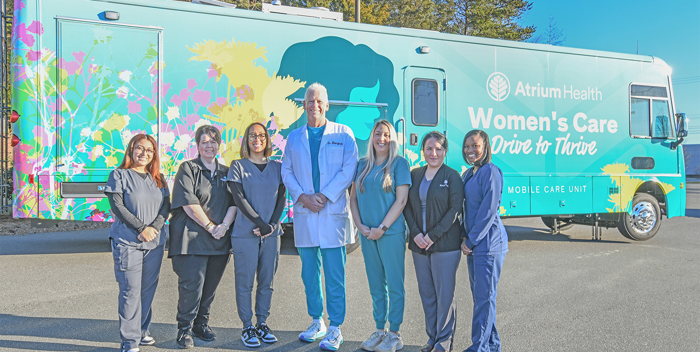 Atrium employees posing in front of women's care drive 