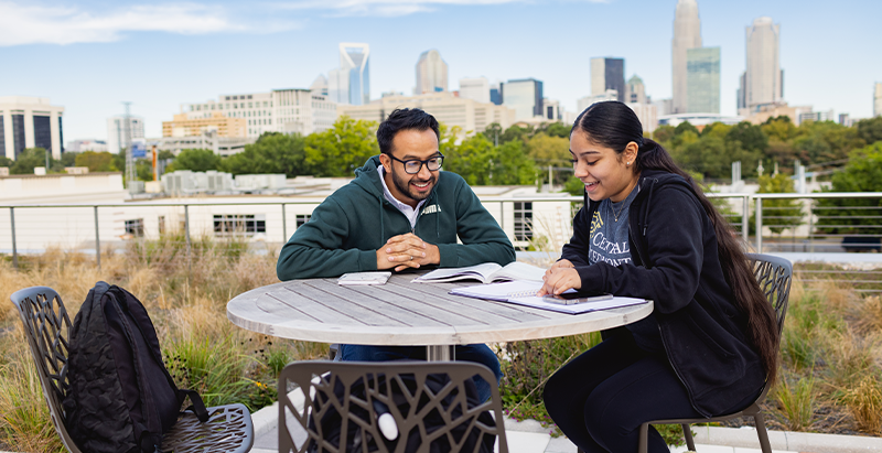 Two students at Parr with Uptown skyline in the background