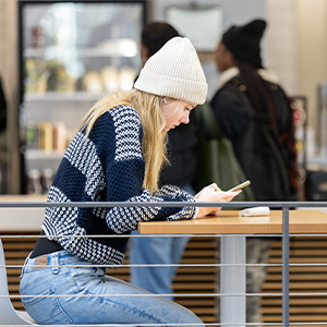 A Central Piedmont student looking at a cell phone in the Parr Center