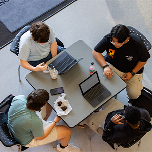 Four students with laptops at Central Piedmont's Levine Campus