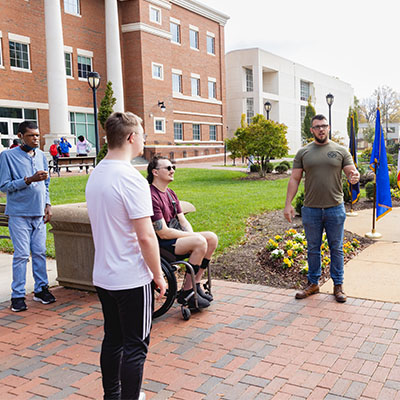 veterans day ceremony with flags and military family and and veteran students on the Quad at Central Piedmont 