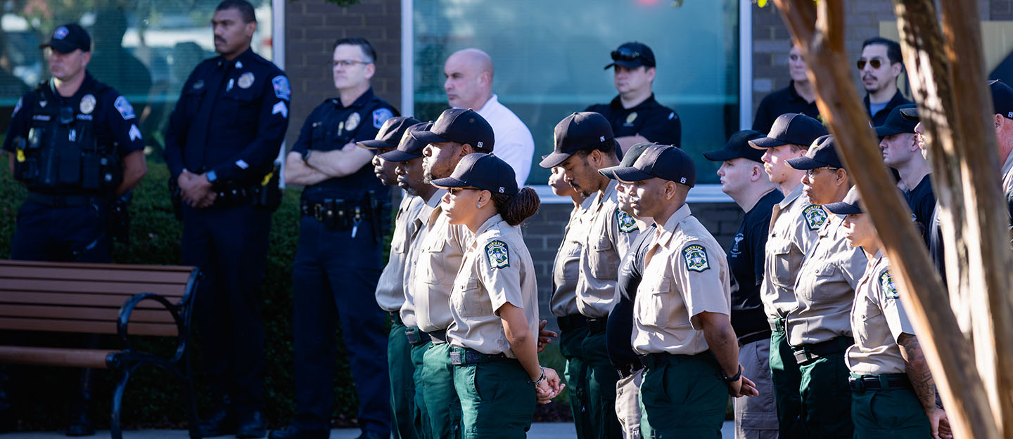veterans day ceremony with military and law enforcement standing outside