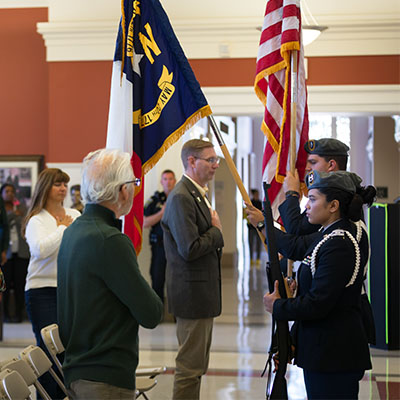 group standing inside Halton Theater for Veterans Day Ceremony
