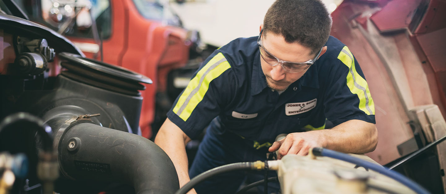 A Central Piedmont student working on a car at the Merancas Campus