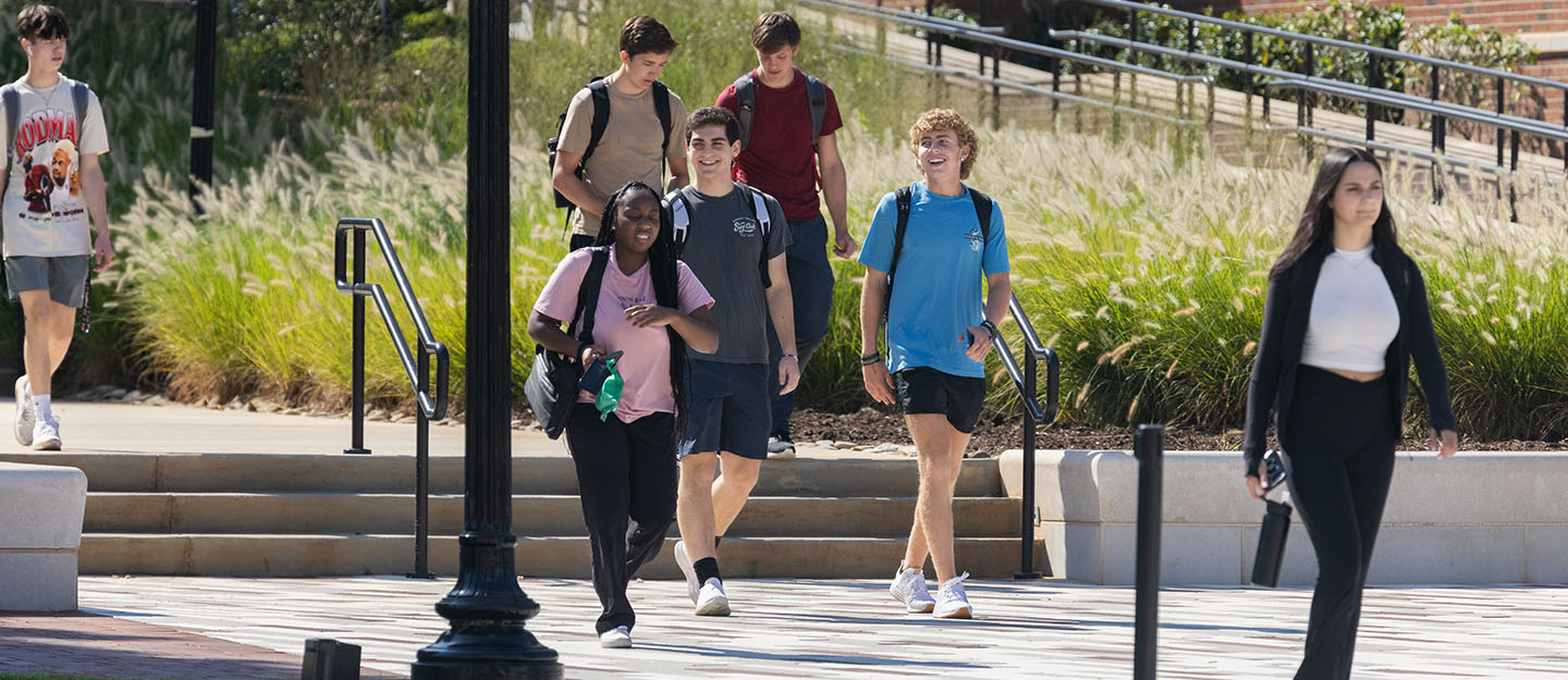 diverse students walking on campus the first day for classes
