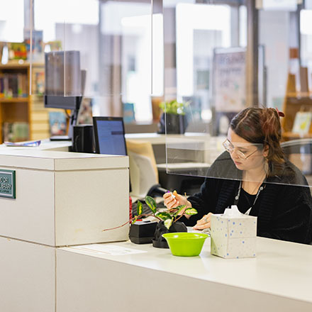 staff sitting at front desk in Harris Library at Central Piedmont Community College