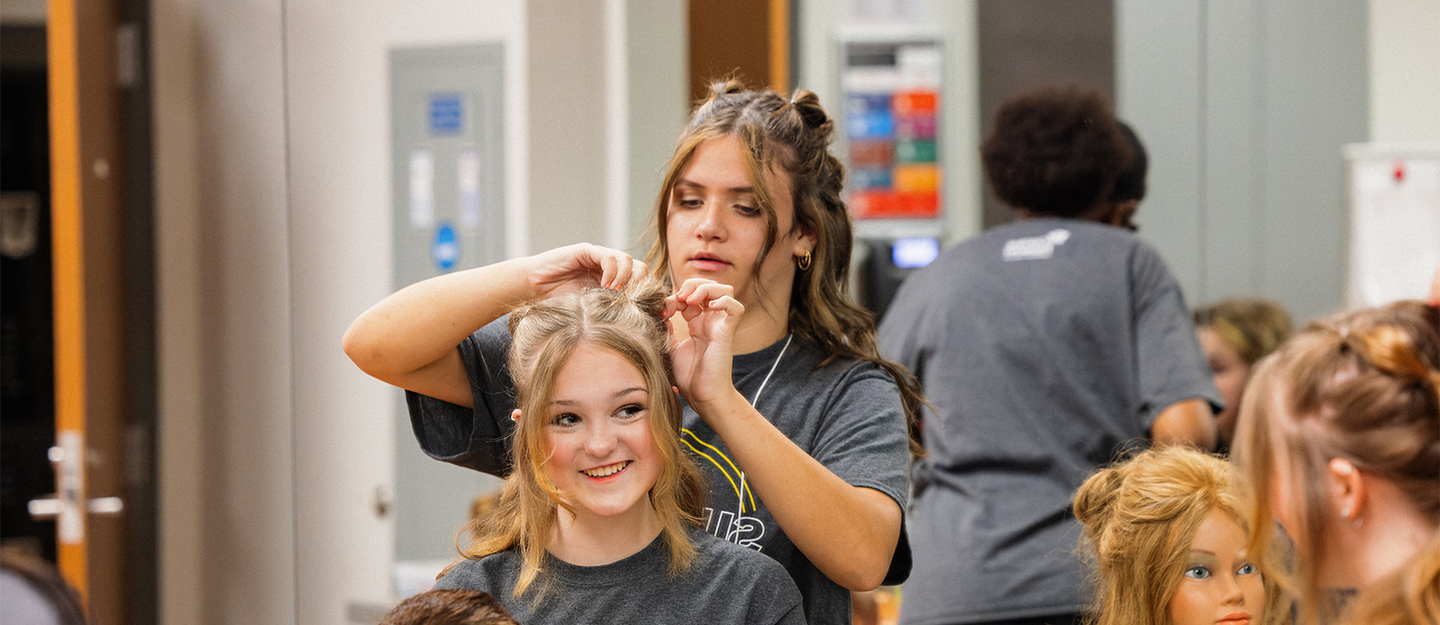 One person doing another person's blonde hair