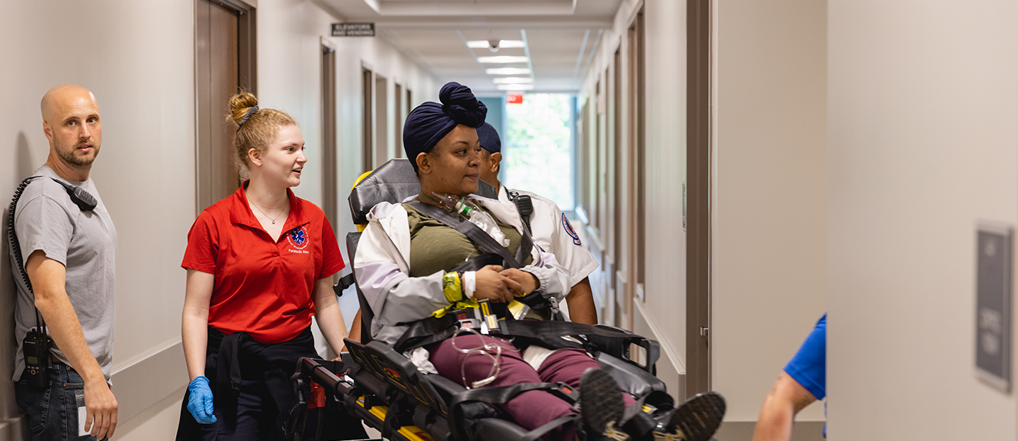 Medical students escorting patient on a stretcher 
