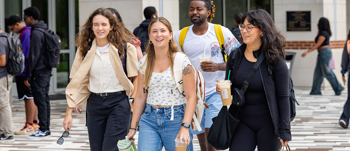 Four Central Piedmont students walking outside of the Parr Center on Central Campus