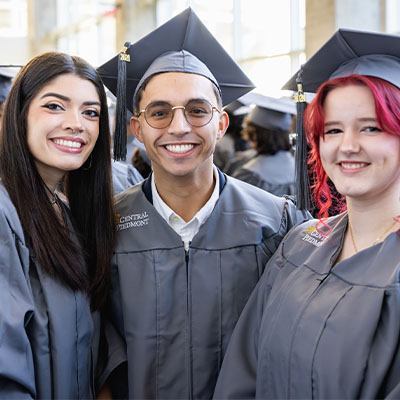 Three Central Piedmont graduates at the Fall 2024 graduation ceremony