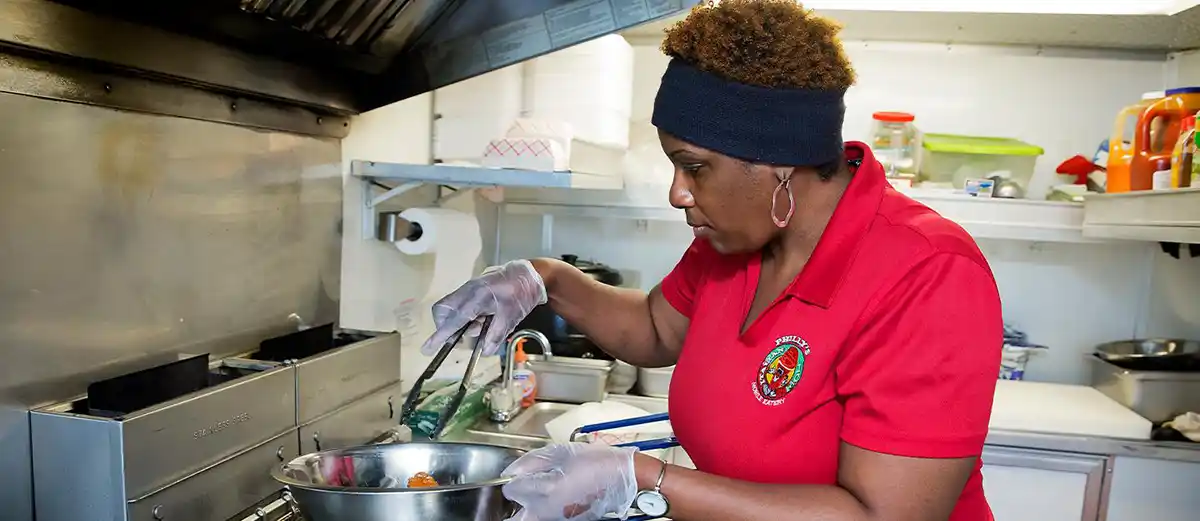 continuing education student cooking in food truck 