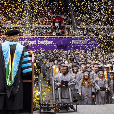 Dr. D at graduation with confetti in the air
