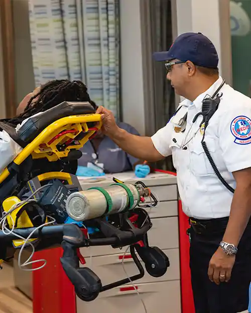 first responder student with patient student on stretcher inside medical classroom on Central Campus at Central Piedmont Community College