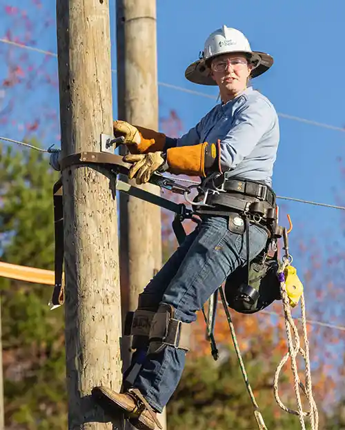 Duke Energy lineworker standing on utility pole looking into the camera, outside at Central Piedmont Community College