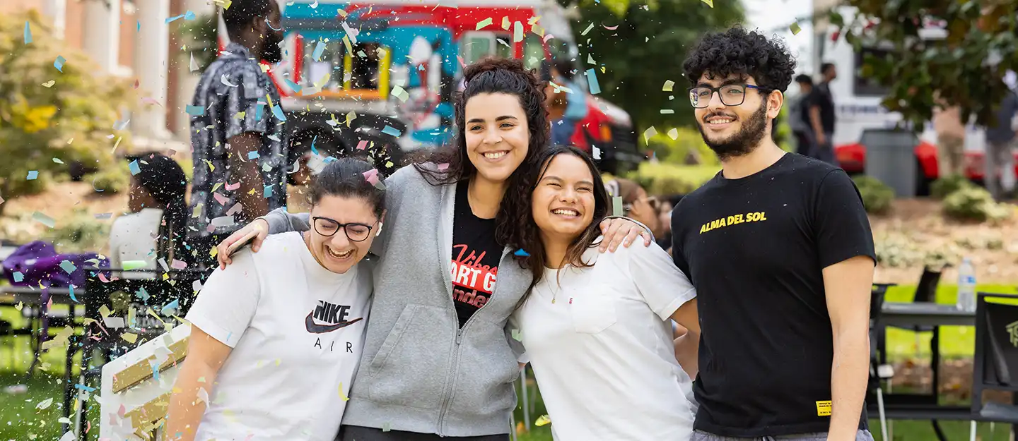 happy diverse students smiling outside celebrating at 60th anniversary of Central Piedmont