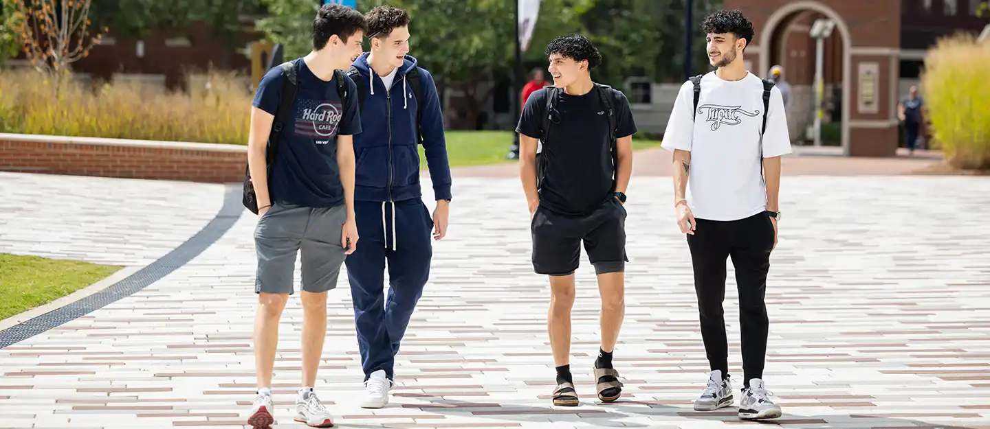 diverse students walking on Central Campus during class change
