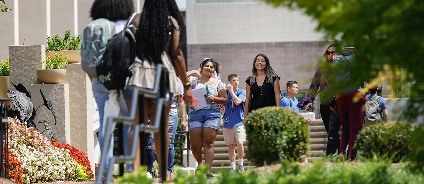 Smiling students walking on Central Piedmont's campus