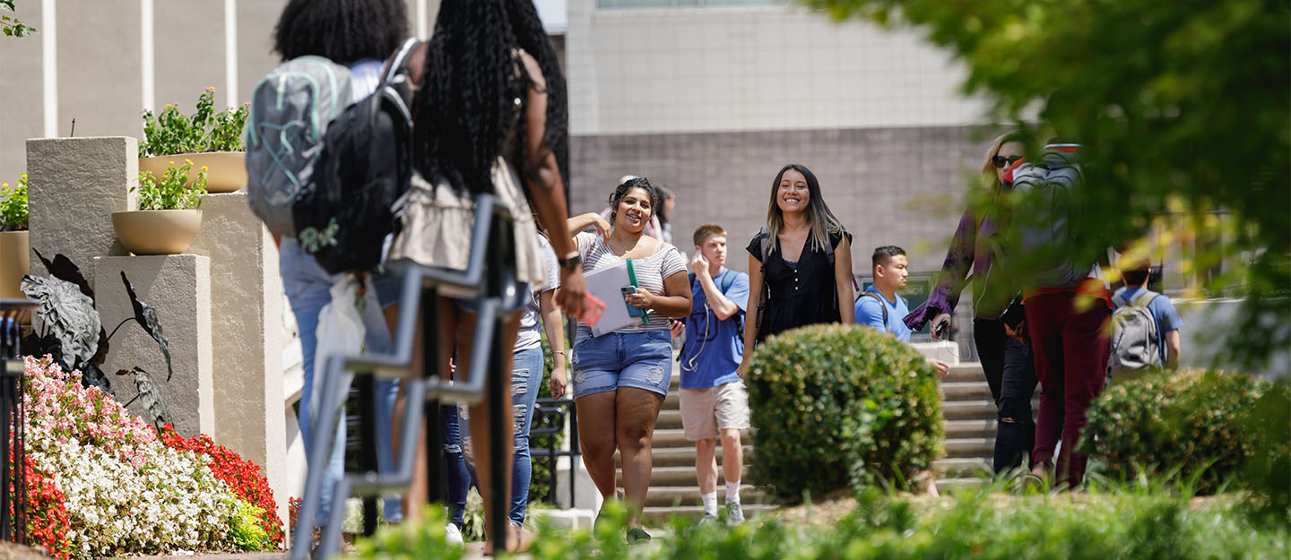 Smiling students walking on Central Piedmont's campus