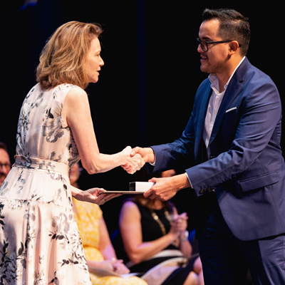 Dr. D shaking a graduate's hand