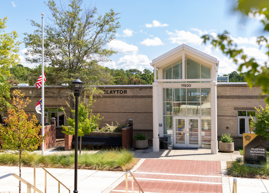 Exterior of brick building with glass entryway and walkways in front on Central Piedmont’s Merancas Campus.