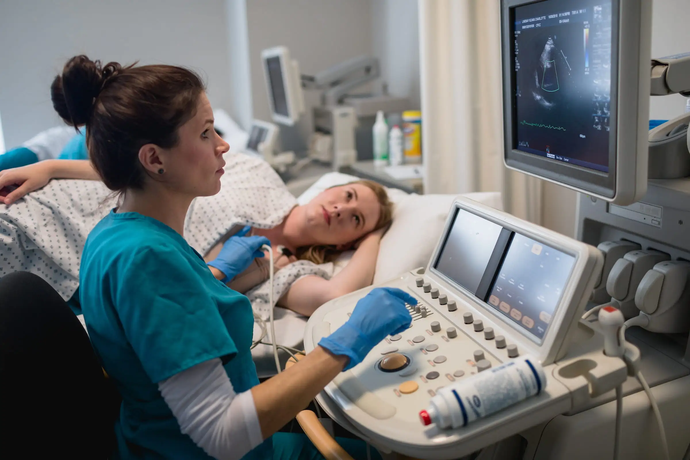 Sonographer performing an ultrasound scan with the image on a monitor