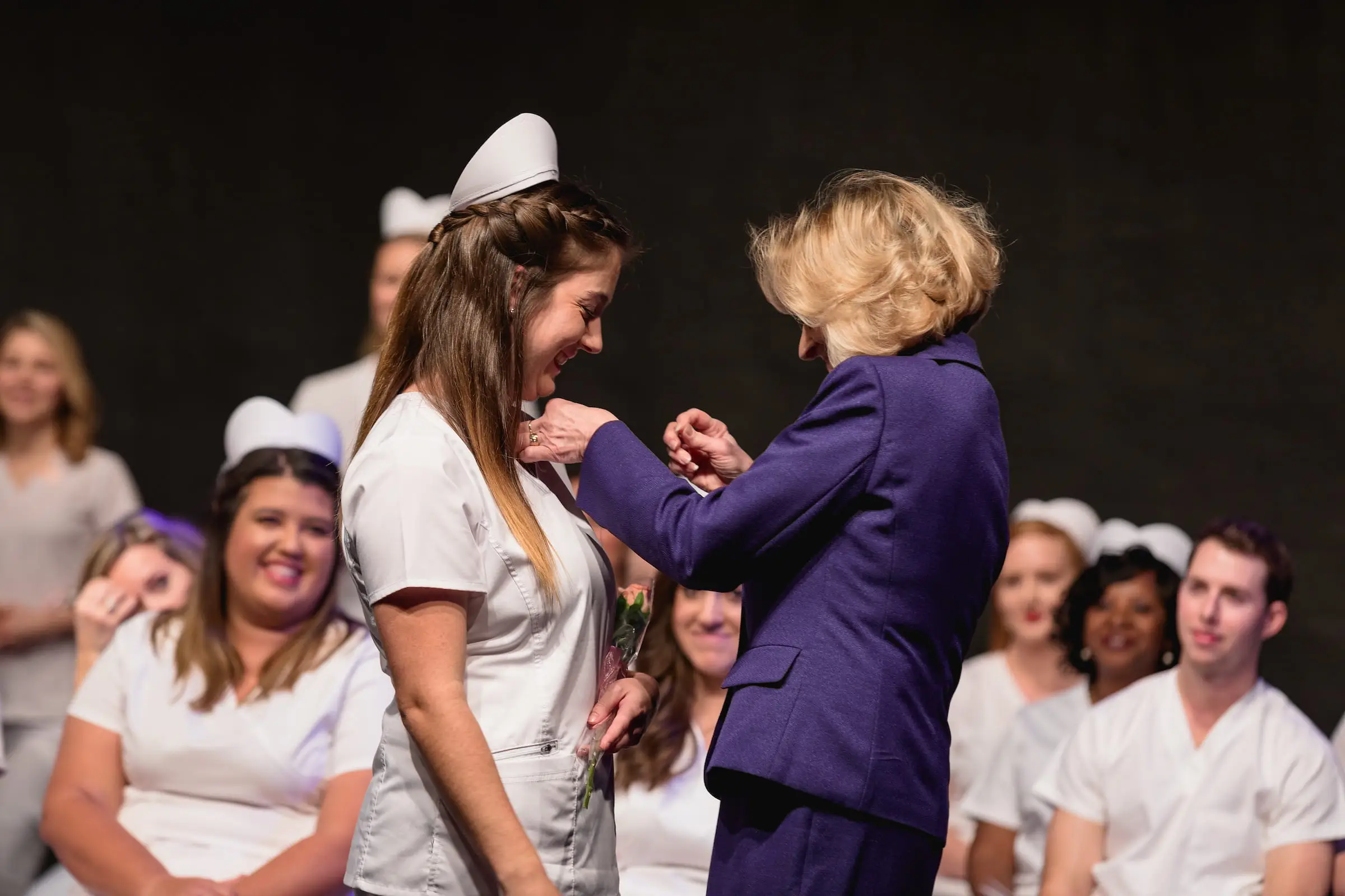 Nursing graduate receiving a pin at the pinning ceremony