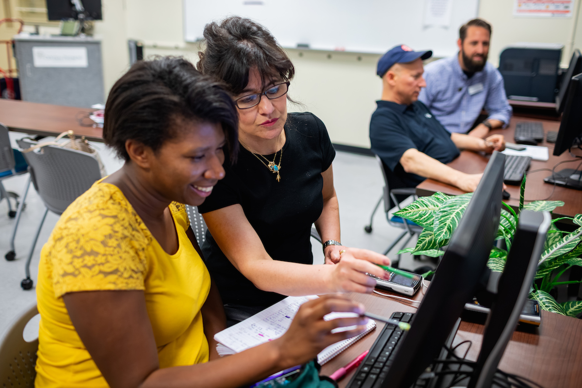 TRIO student and mentor looking at a computer screen together.